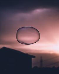 Low angle view of bubbles against sky at sunset