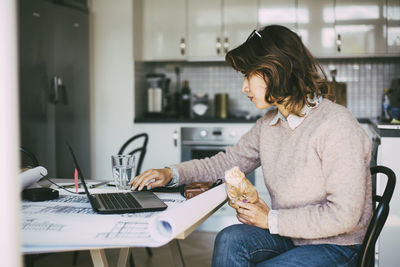 Woman using mobile phone at home