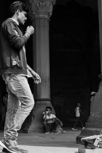 Man and woman sitting at entrance of building