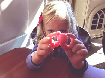 Close-up of girl holding camera
