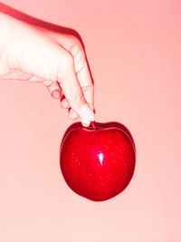 Midsection of woman holding red apple