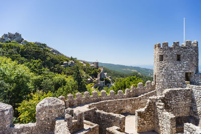 Ancient structure against clear blue sky