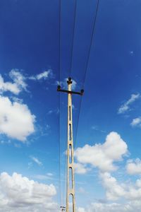 Low angle view of communications tower against blue sky