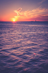 Scenic view of sea against romantic sky at sunset
