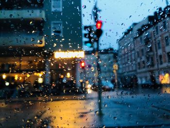 City street seen through wet glass window