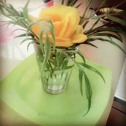 Close-up of yellow flower vase on table