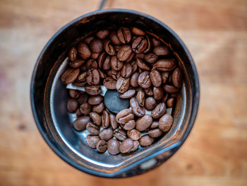 Coffee beans in coffee grinder.