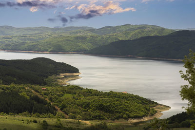 Scenic view of lake and mountains against sky