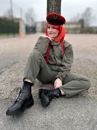 Portrait of young woman wearing hat sitting on snow