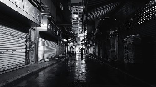 Street amidst buildings at night