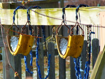 Close-up of swings at playground during winter