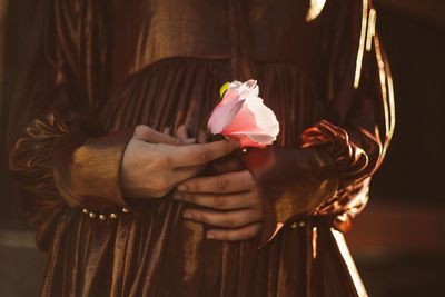 Close-up of hand holding rose