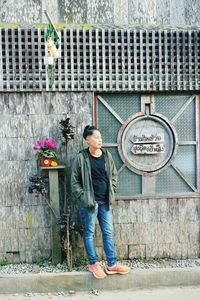 Portrait of man leaning against wall