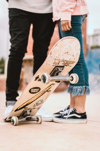 Low section of boy standing on skateboard