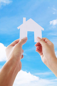 Close-up of man holding blue sky