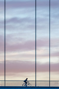 People walking on bridge against sky
