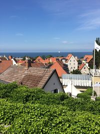 Houses and buildings against blue sky