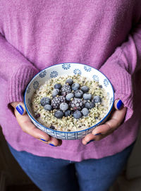 High angle view of woman holding breakfast bowl