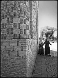 Rear view of couple walking on walkway