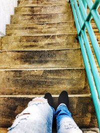 Low section of man standing on staircase