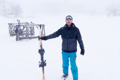 Full length of man with ski in hand