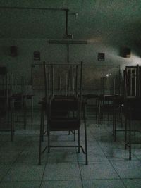 Empty chairs and table in abandoned building