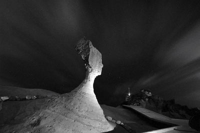 Scenic view of rock formations against sky at night