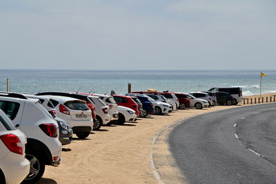 View of road by sea against sky