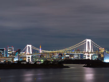 Rainbow bridge and tokyo tower at night.