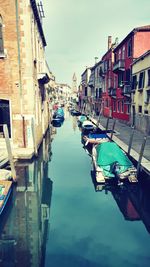 Boats in canal with buildings in background