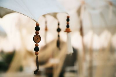 Close-up of decoration hanging on wood