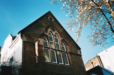 Low angle view of building against clear blue sky