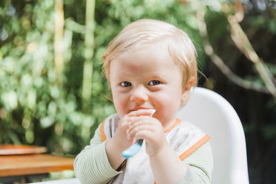 Portrait of cute boy holding baby girl