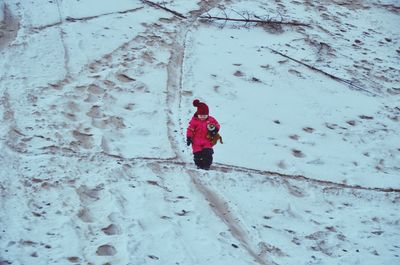 Person walking on snow covered land