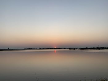 Scenic view of sea against clear sky during sunset