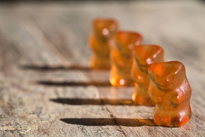 Close-up of gummi bears on wooden table