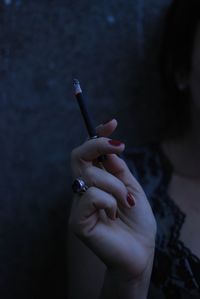 Close-up of woman holding cigarette