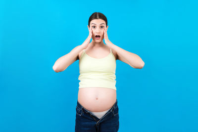 Woman standing against blue background