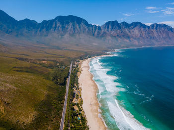 Scenic view of sea and mountains against sky