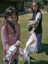 Full length of woman holding bird