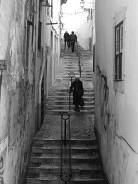 Rear view of people walking on street