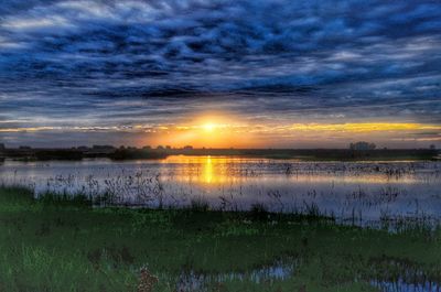 Scenic view of lake against sky during sunset