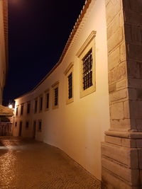 Illuminated building against clear sky at night