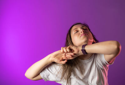 Beautiful young woman against pink background