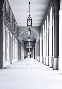 Rear view of person walking in corridor of building