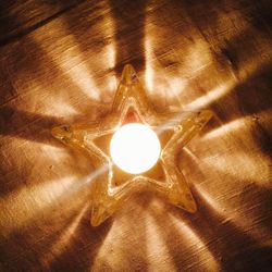 Close-up of illuminated lamp on table