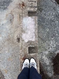 Low section of man standing on retaining wall