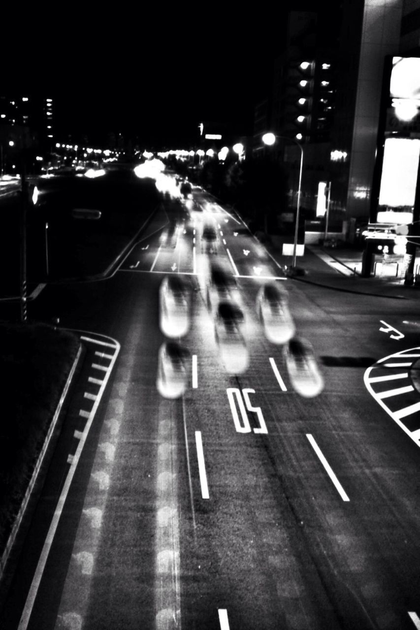 transportation, illuminated, night, city, building exterior, architecture, built structure, street, mode of transport, city life, city street, car, road, road marking, land vehicle, incidental people, high angle view, traffic, the way forward, zebra crossing