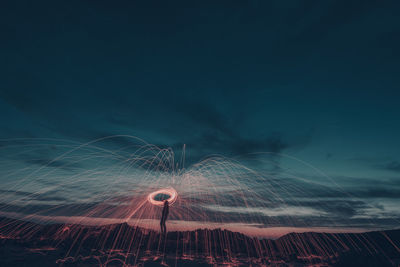 Aerial view of illuminated city against sky at night