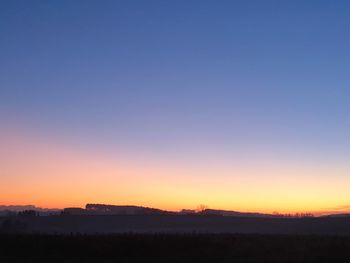 Scenic view of silhouette landscape against clear sky during sunset